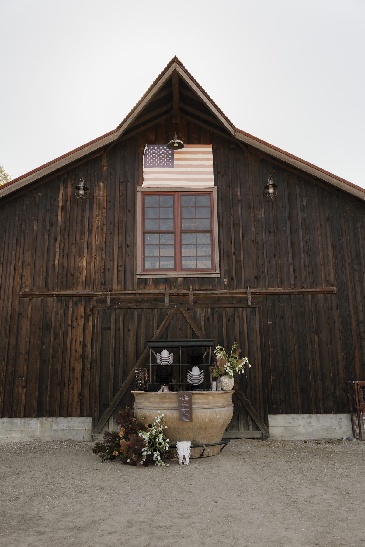 The timber barn with its flag and courtyard