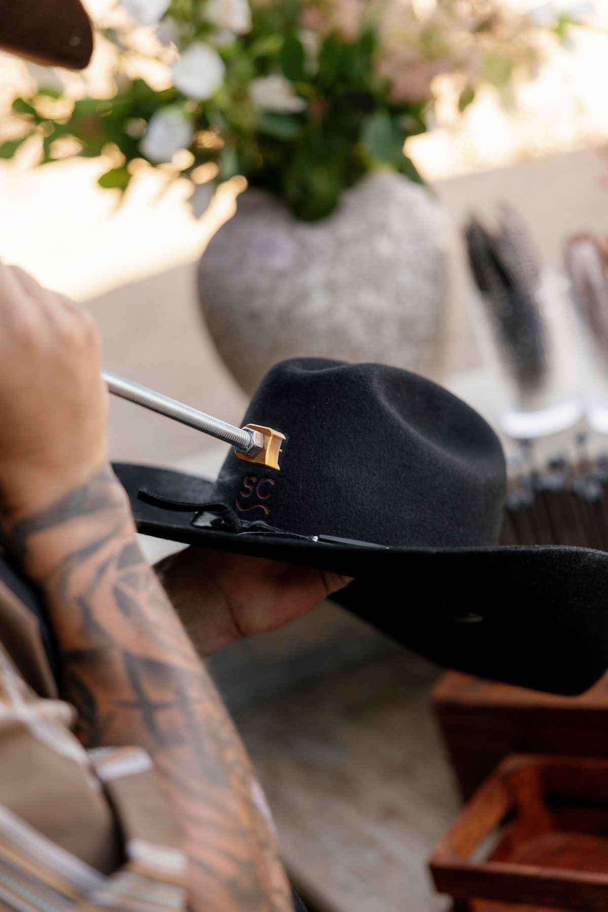 A custom hat being branded at the hat bar
