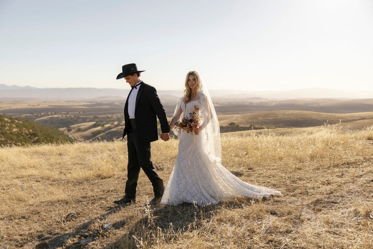 The couple walking the ridge above the valley