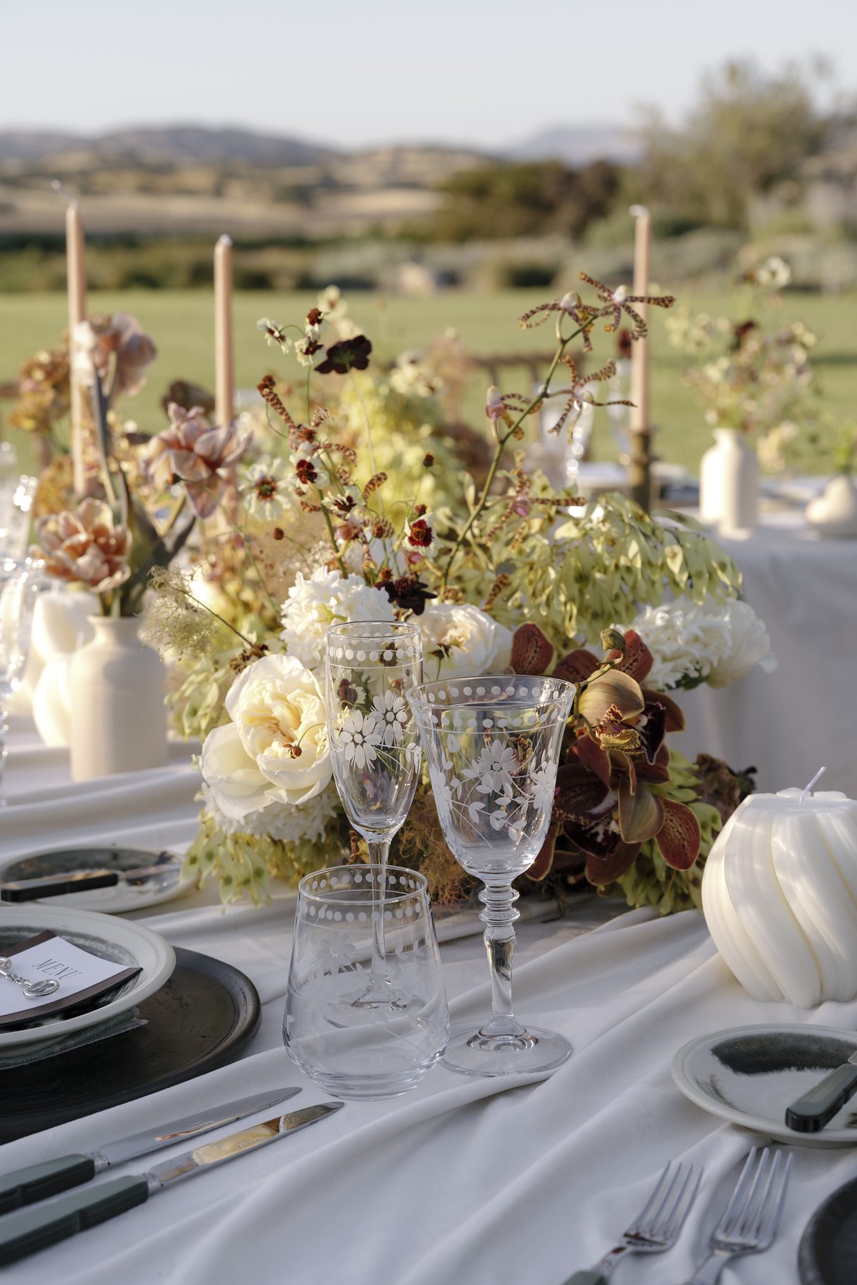 A tablescape of autumn florals and crystal