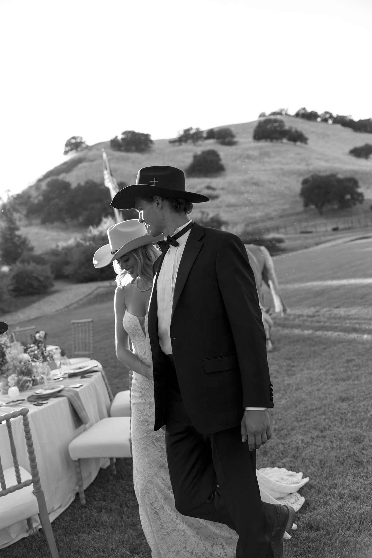 The couple walking past the tables, in black and white