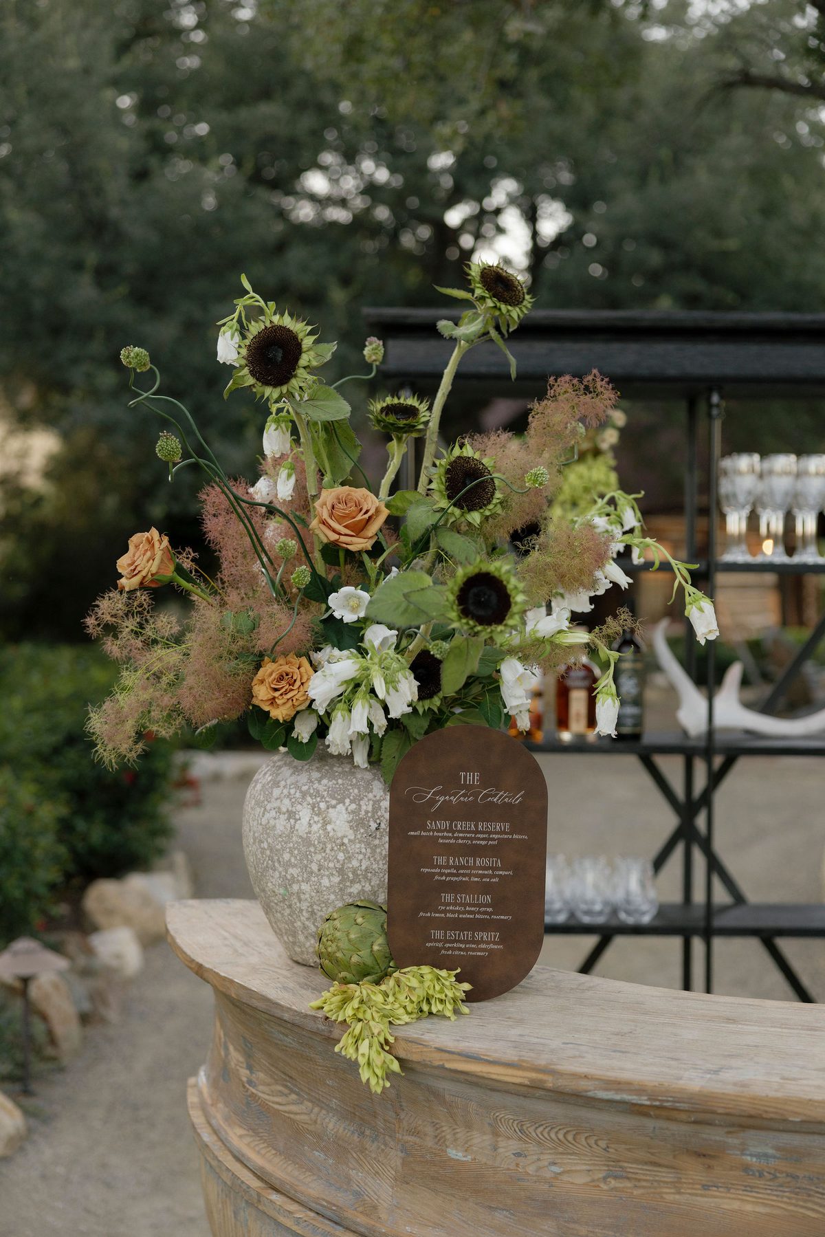 Florals and glassware at the garden bar
