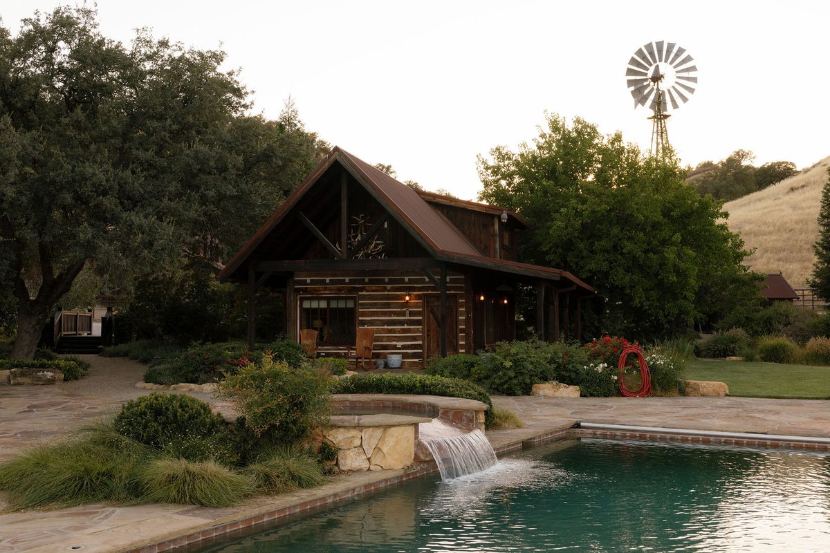 The pool, its waterfall, and the lodge and windmill beyond