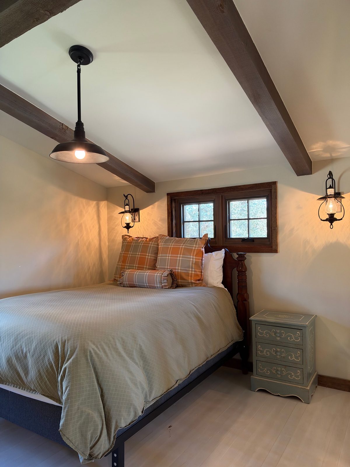 A guest bedroom under exposed beams